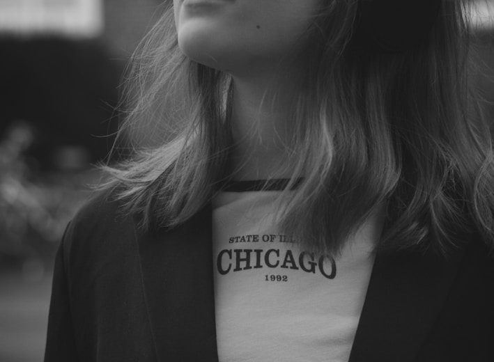 a woman wearing headphones standing in front of a building