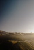 A serene landscape with soft hills and a clear sky.