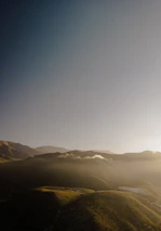 A peaceful Patagonian landscape blending greenery and earthy tones under soft sunlight.