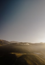A peaceful green landscape with rolling hills and clear skies in Serrana.
