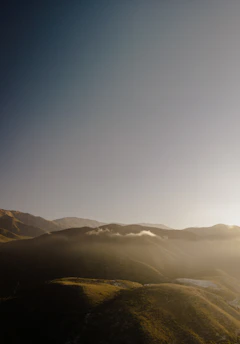 A peaceful Patagonian landscape blending greenery and earthy tones under soft sunlight.