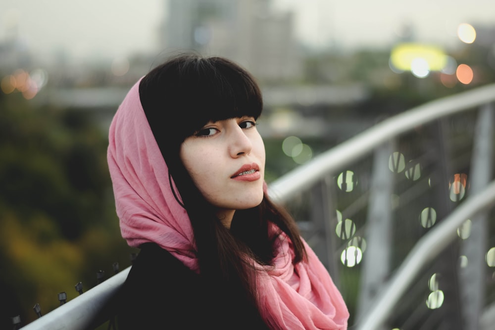 a woman with a pink scarf on her head