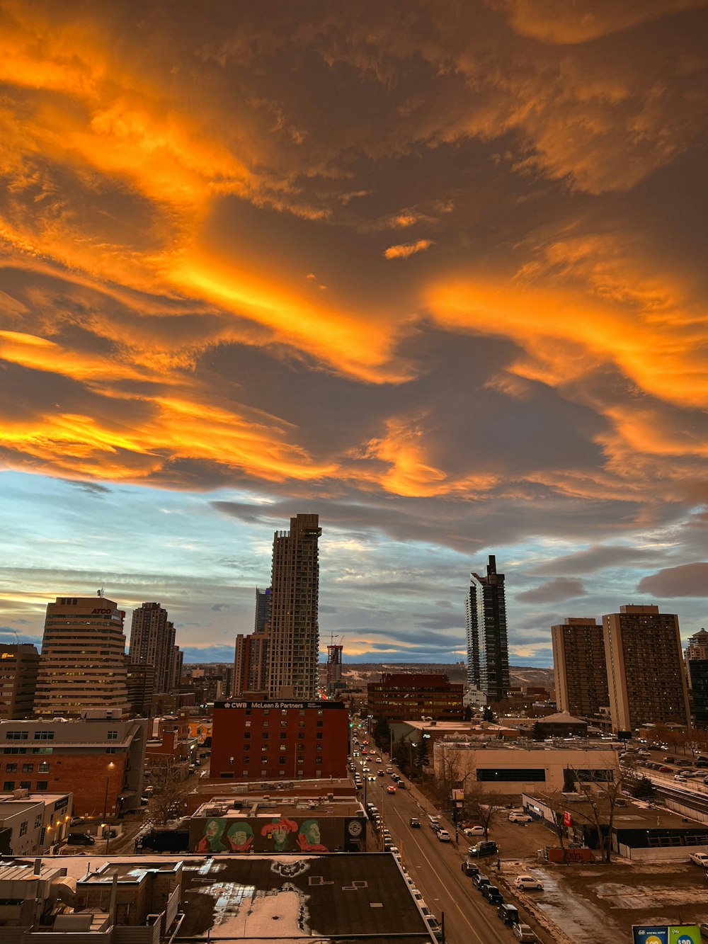 a view of a city at sunset with clouds in the sky