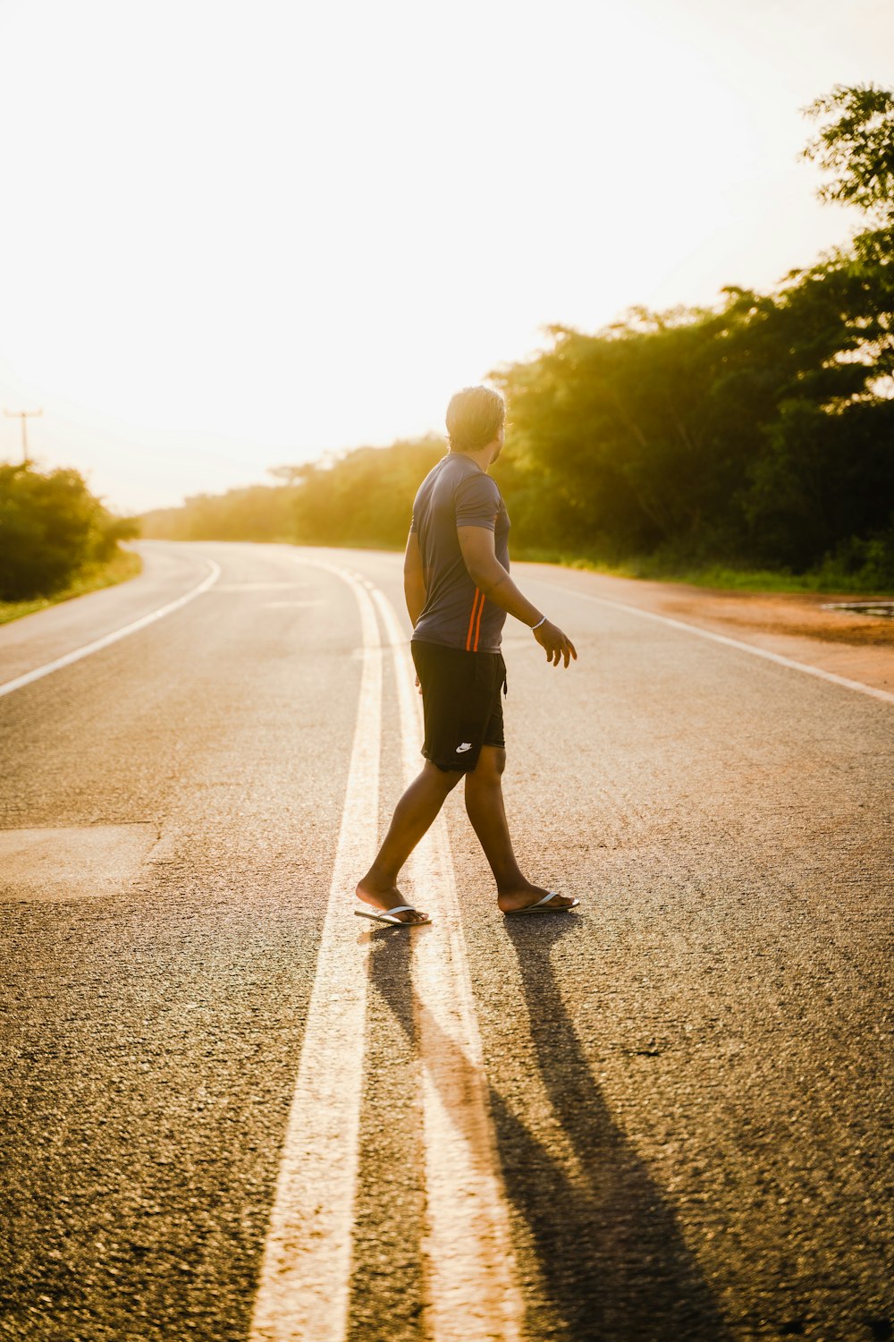 a man riding a skateboard down the middle of a road