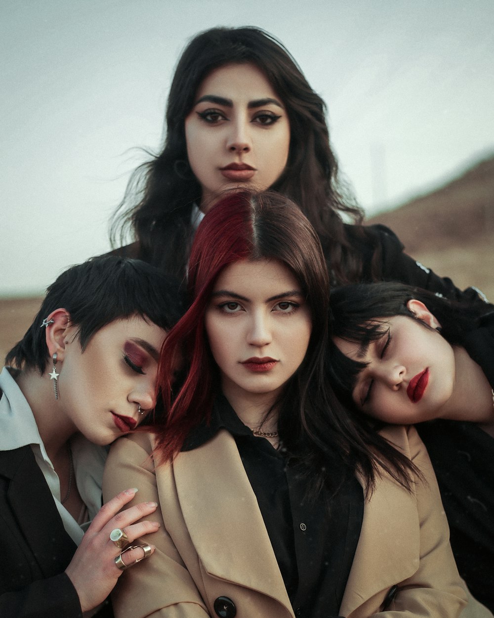 a group of three women standing next to each other