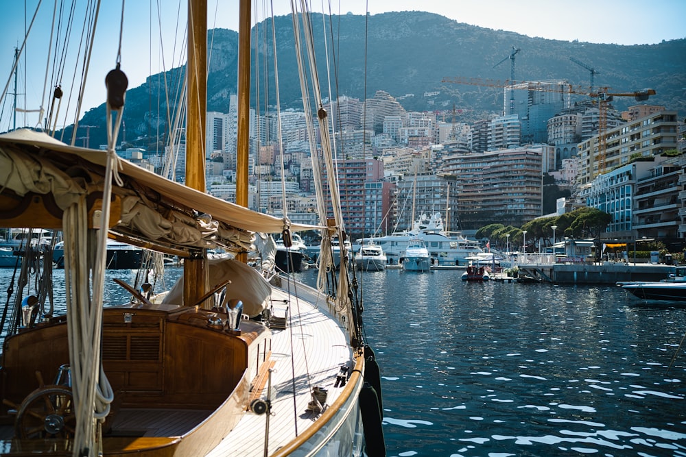 a sailboat in a harbor with a city in the background