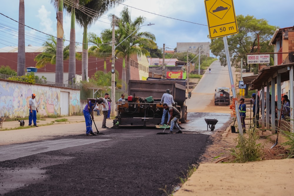 a group of men working on a street