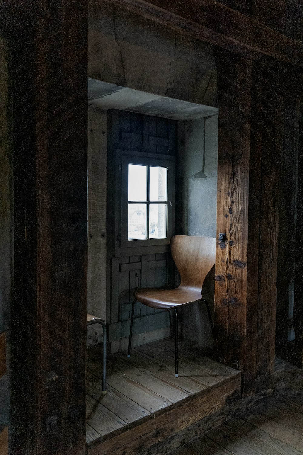 a chair sitting in a room next to a window