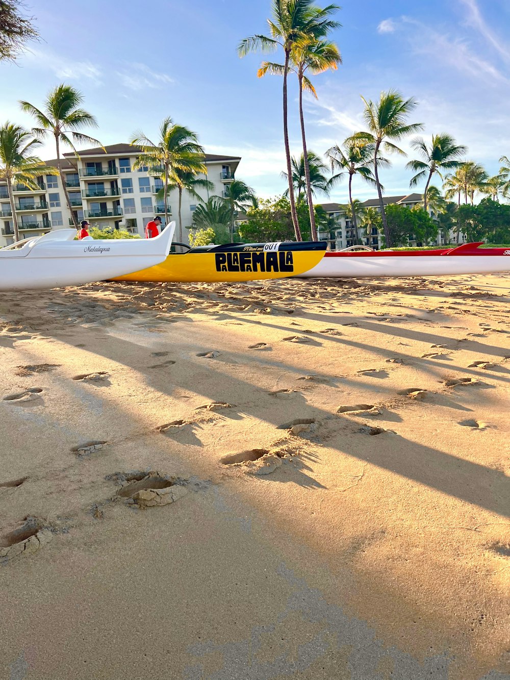 a couple of boats sitting on top of a sandy beach