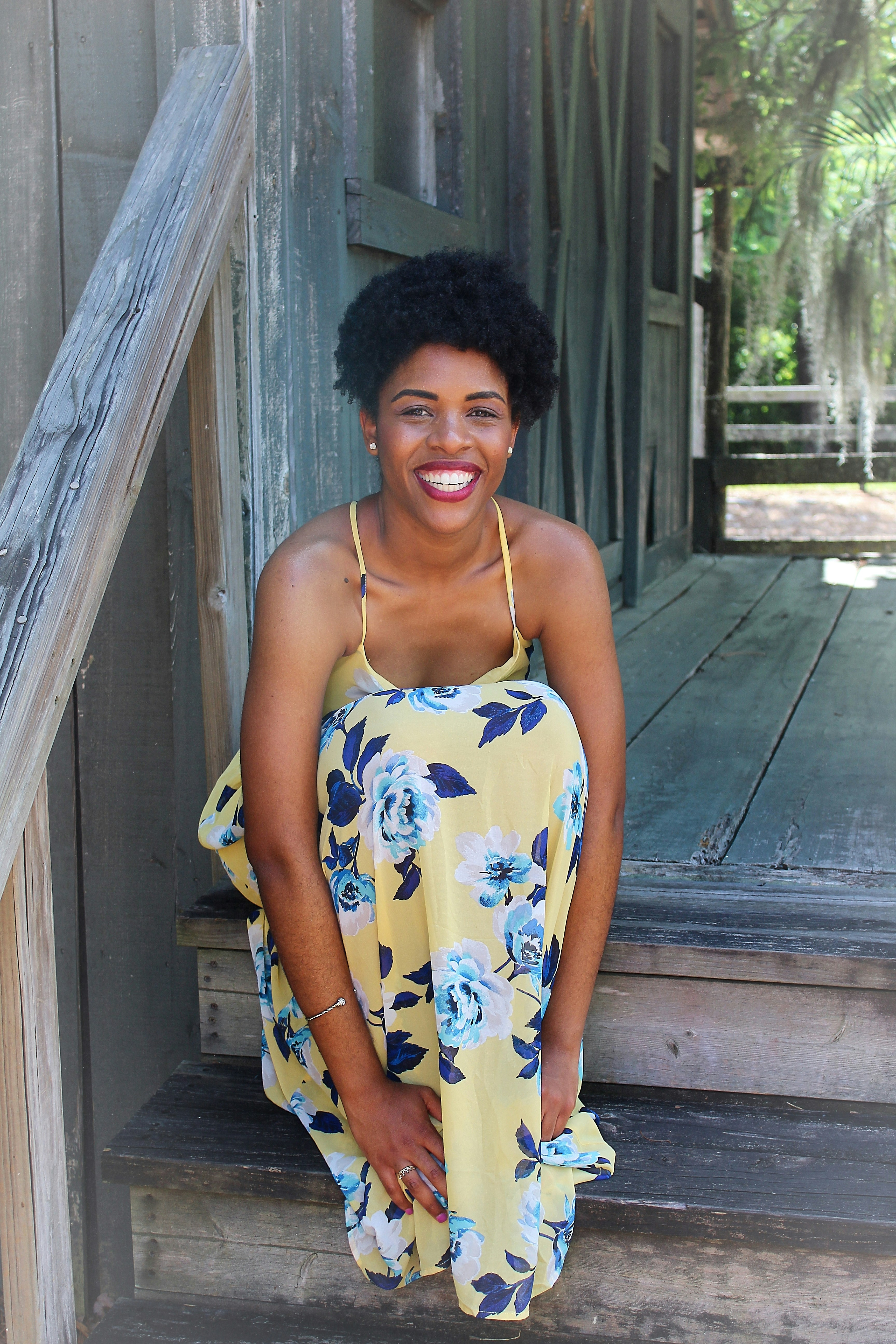 a woman in a yellow and blue floral dress