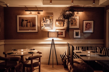 Cozy dining area with softly lit tables and elegant place settings.