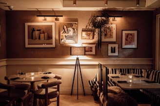 A cozy dining area featuring elegant wall art and soft lighting.