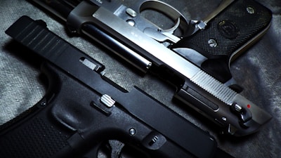 a close up of a gun and a knife