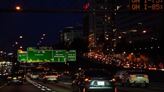 A busy highway with digital displays showing real-time vehicle emission data.