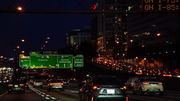 A busy highway with digital displays showing real-time vehicle emission data.
