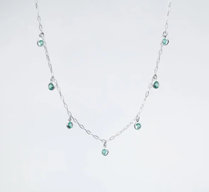 A beautiful silver necklace adorned with sparkling gemstones.