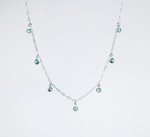 Silver necklace with pendant on display