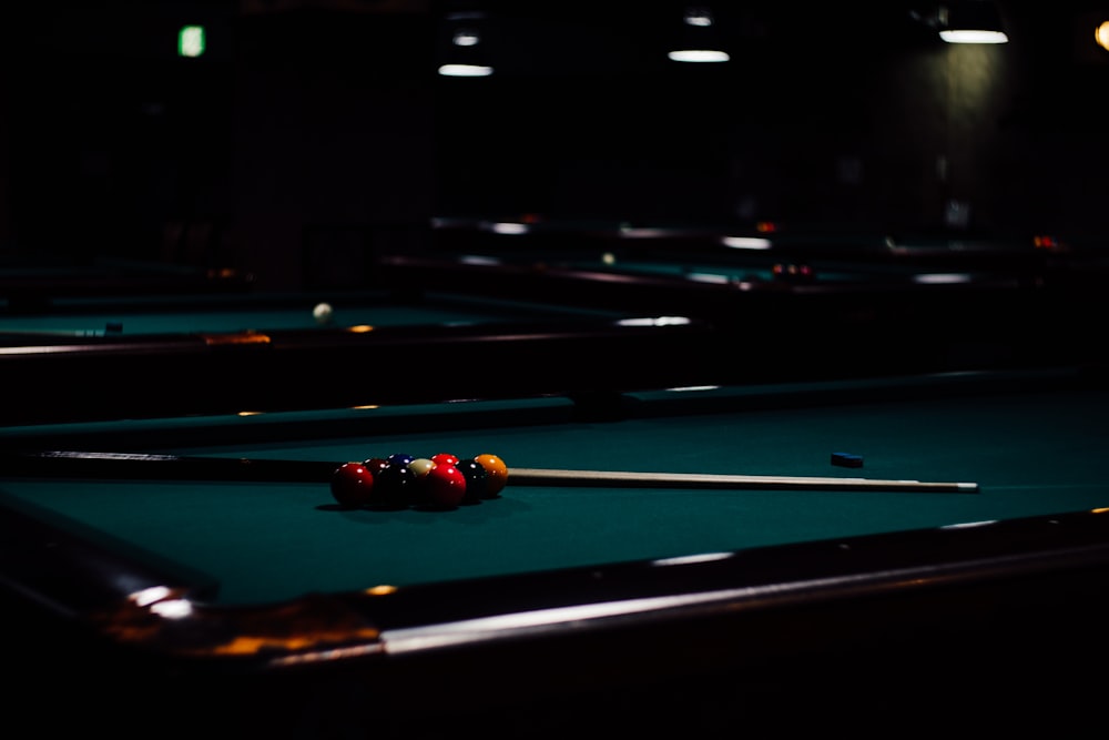 a pool table with two cues and a ball on it