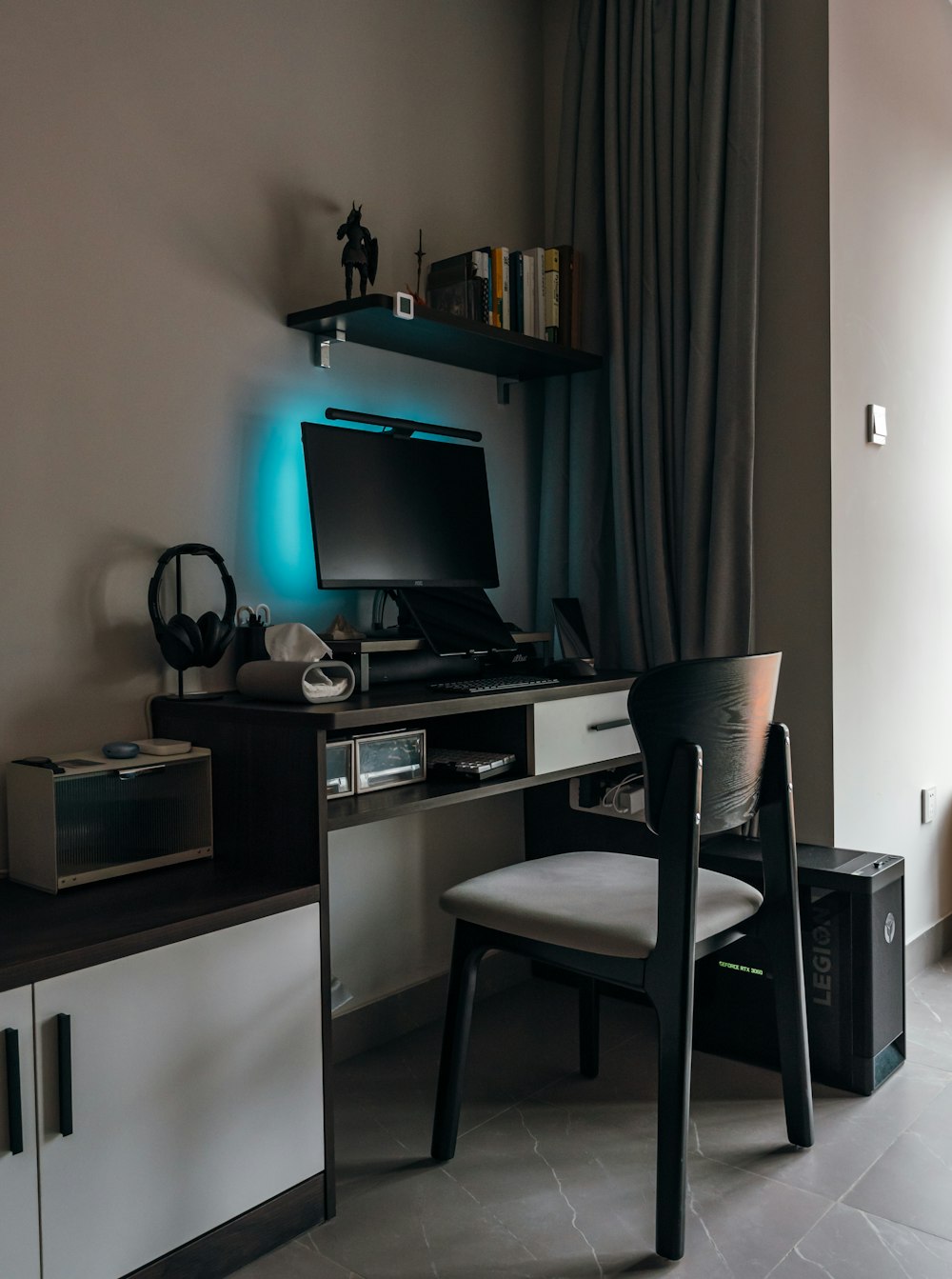 a desk with a computer on top of it