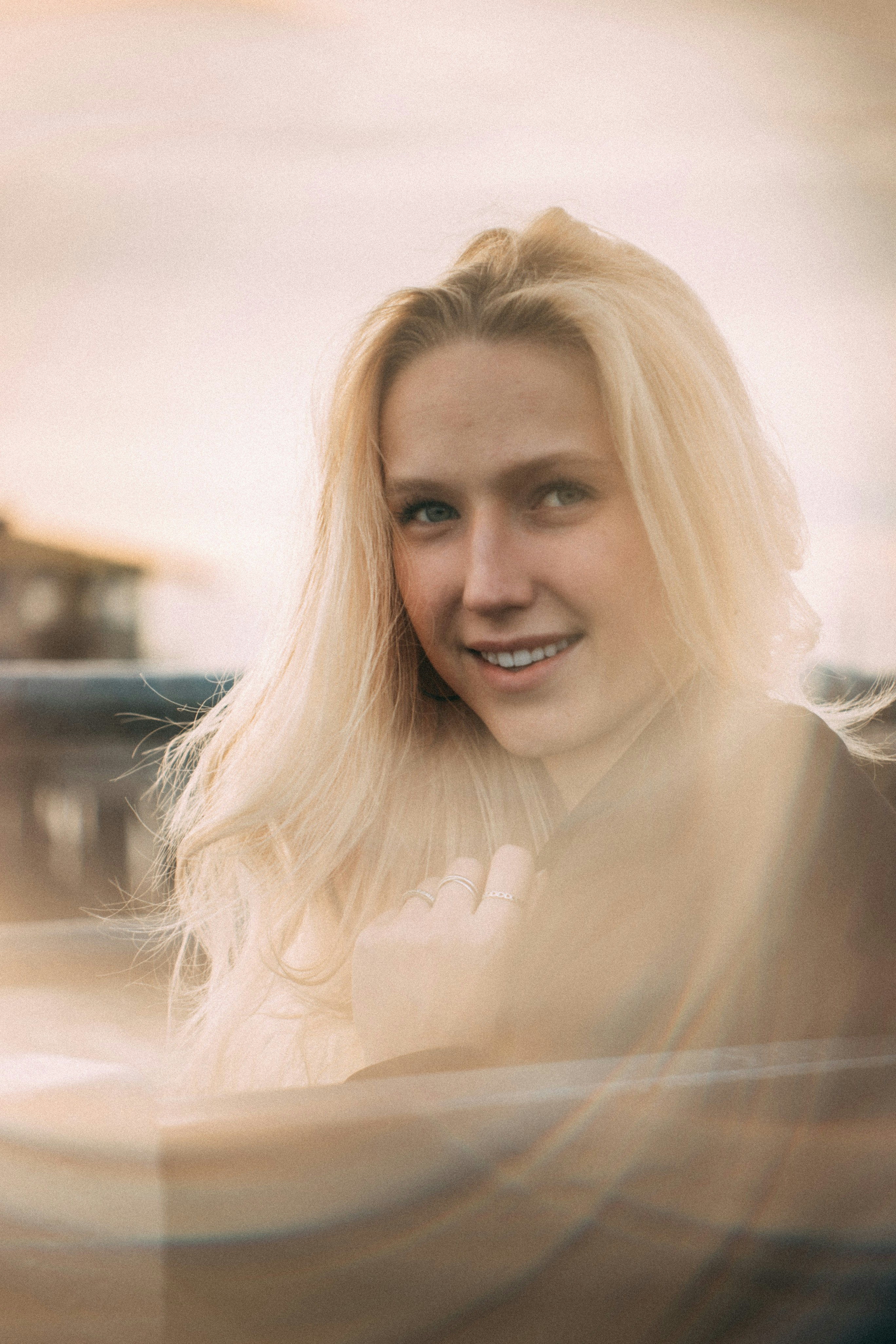 a woman with blonde hair is smiling for the camera