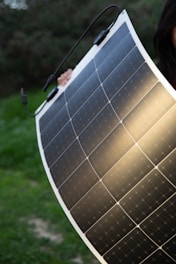 a woman holding a solar panel in her hands