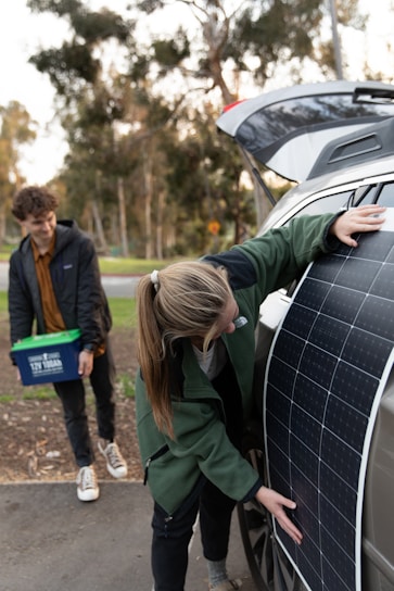 A team loading solar panels onto a truck for free pickup service.
