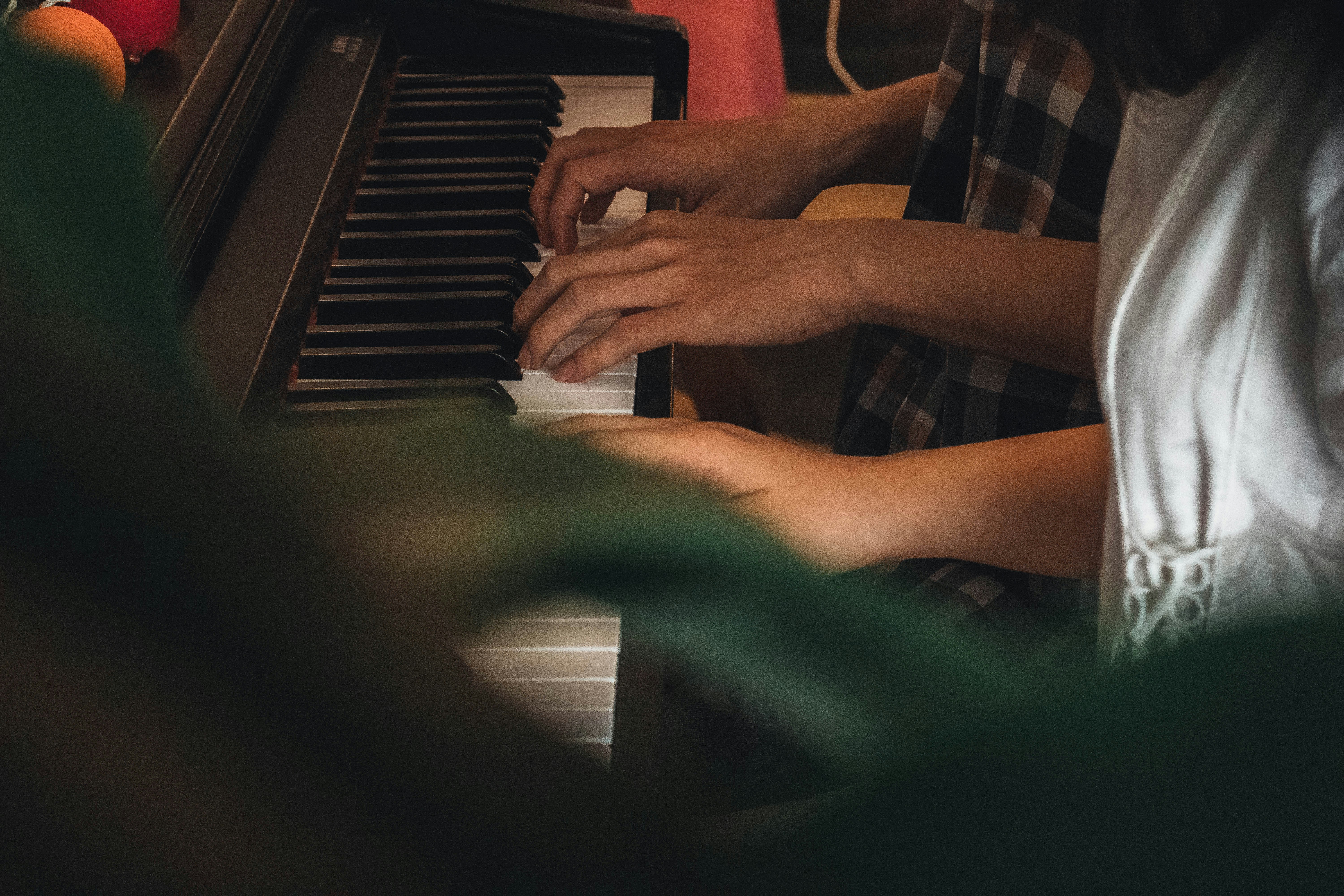 a person playing a piano in a room