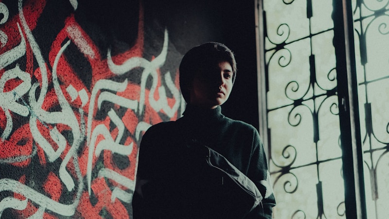 Man posing with graffiti art