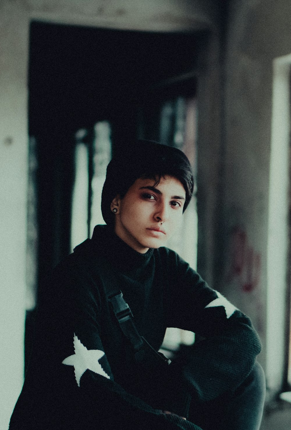 a young man sitting on a chair in a room