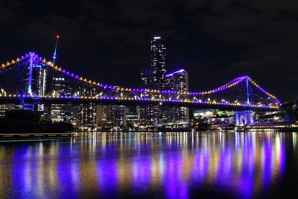 a large bridge over a body of water at night