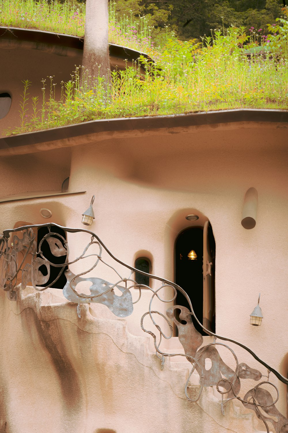 a building with a green roof and a balcony