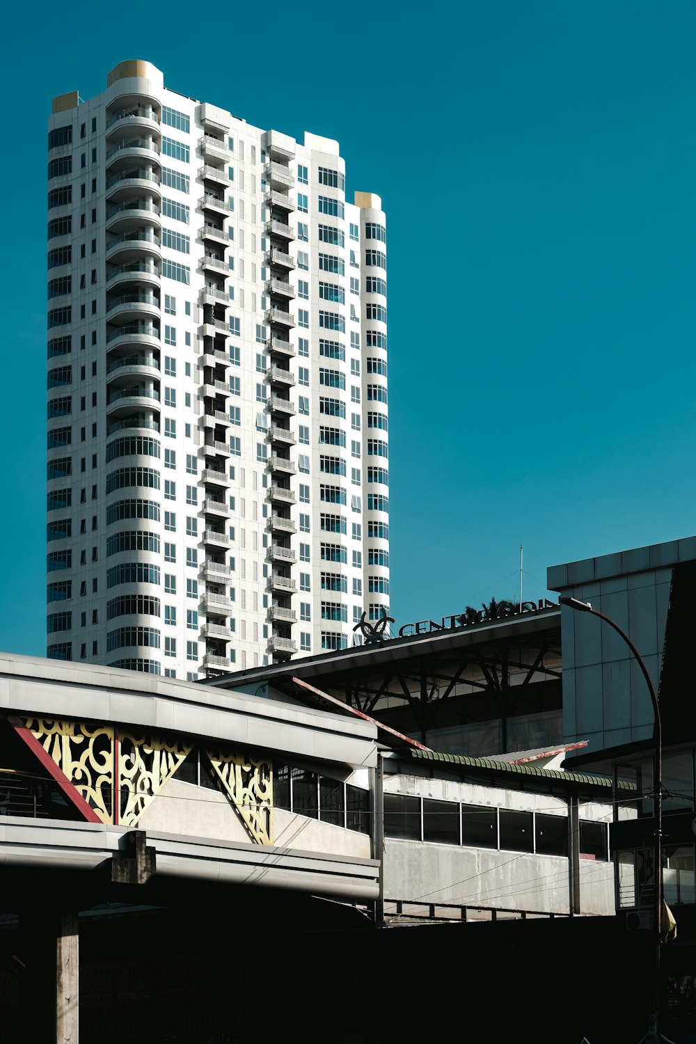 a train traveling over a bridge next to tall buildings