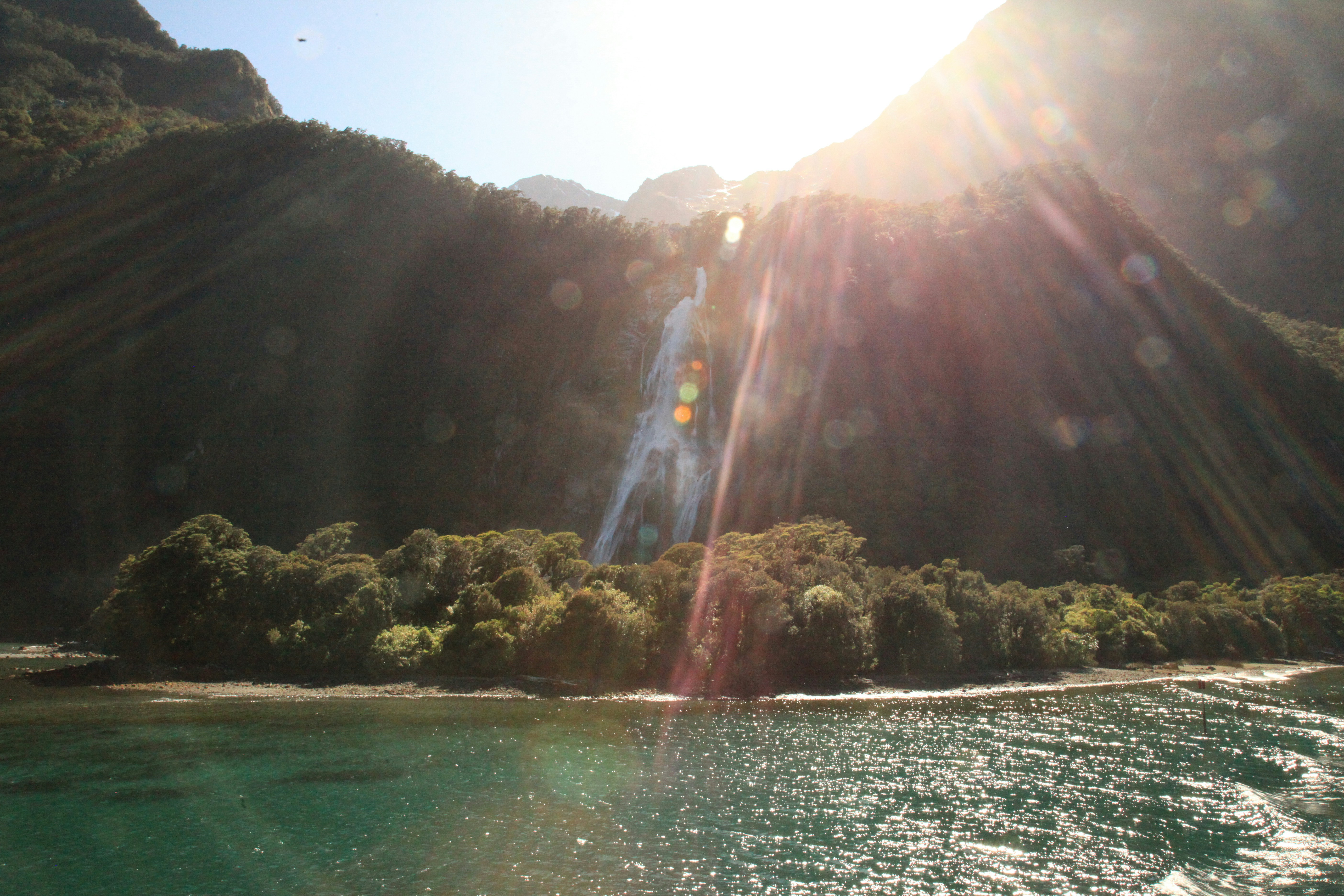 a body of water with a waterfall in the middle of it