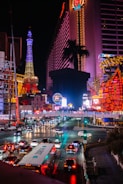 a city street filled with lots of traffic at night