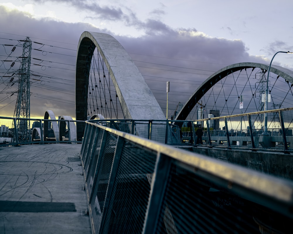 a bridge over a body of water with power lines in the background