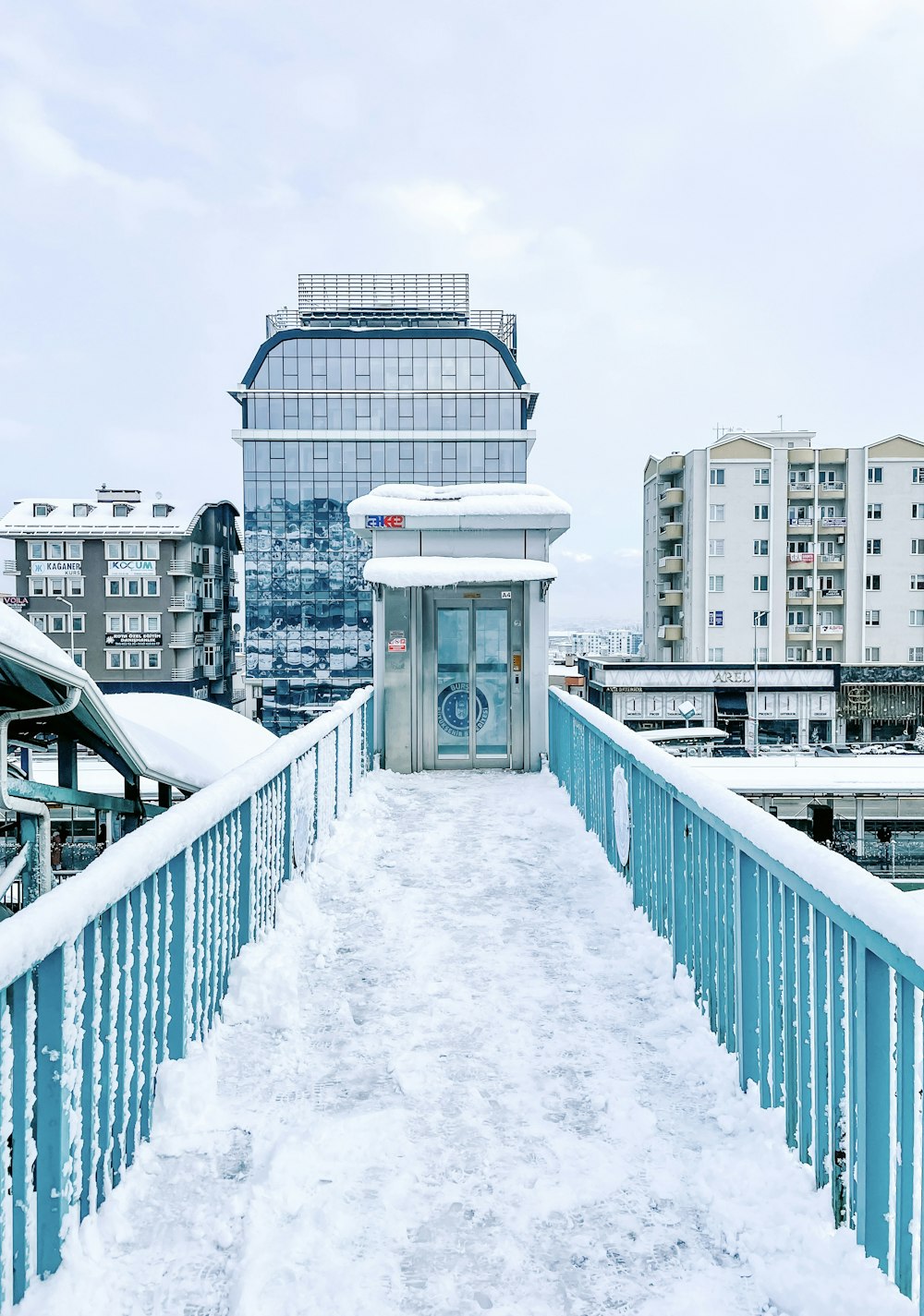 a walkway in the snow leading to a building