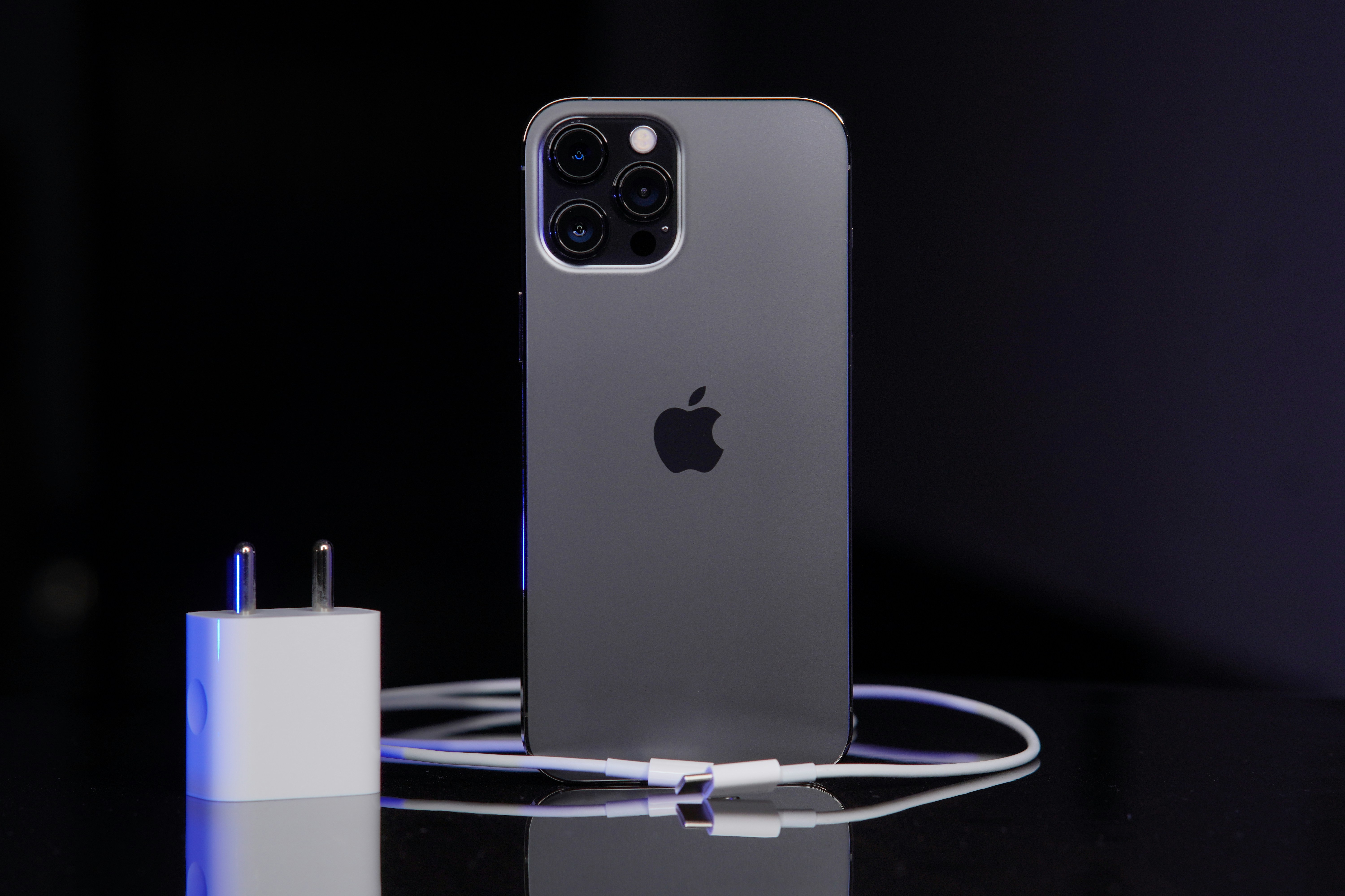 iPhone lightning cable on dark surface, Apple accessory product photography