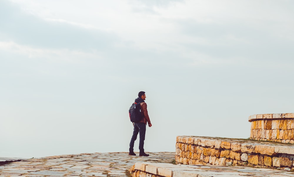 a man standing on top of a stone walkway