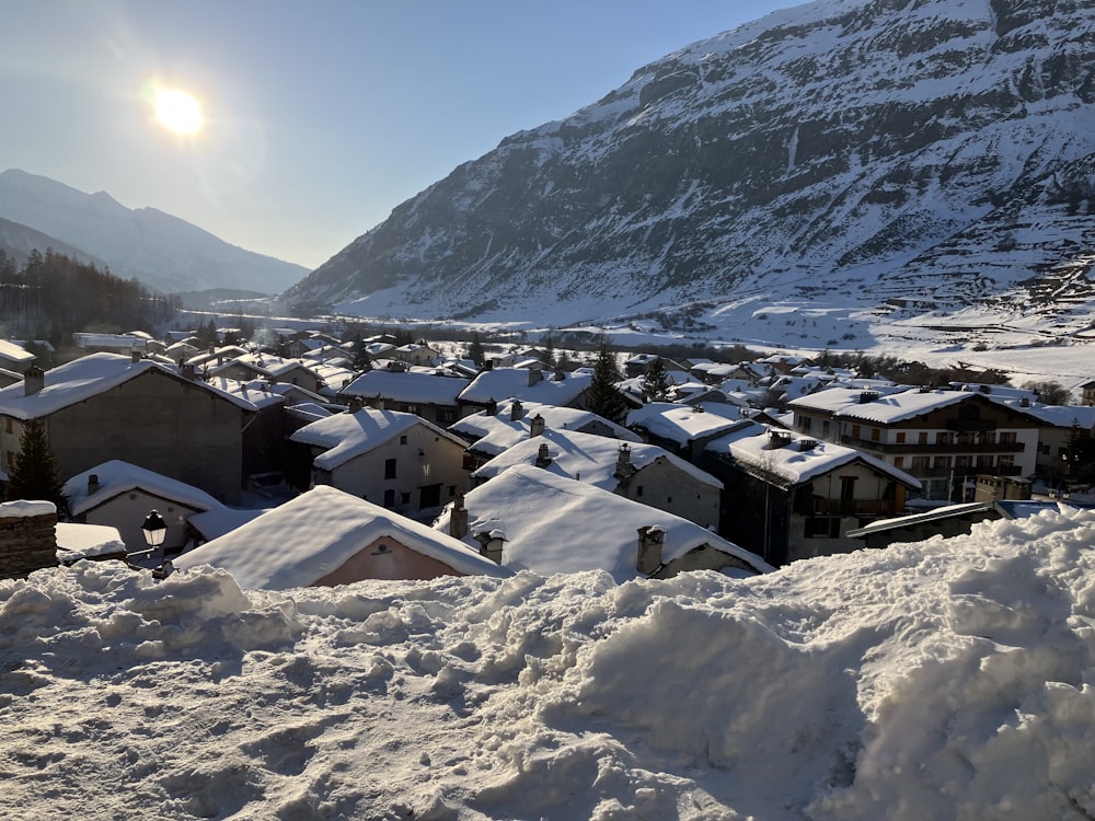 a view of a town in the mountains covered in snow