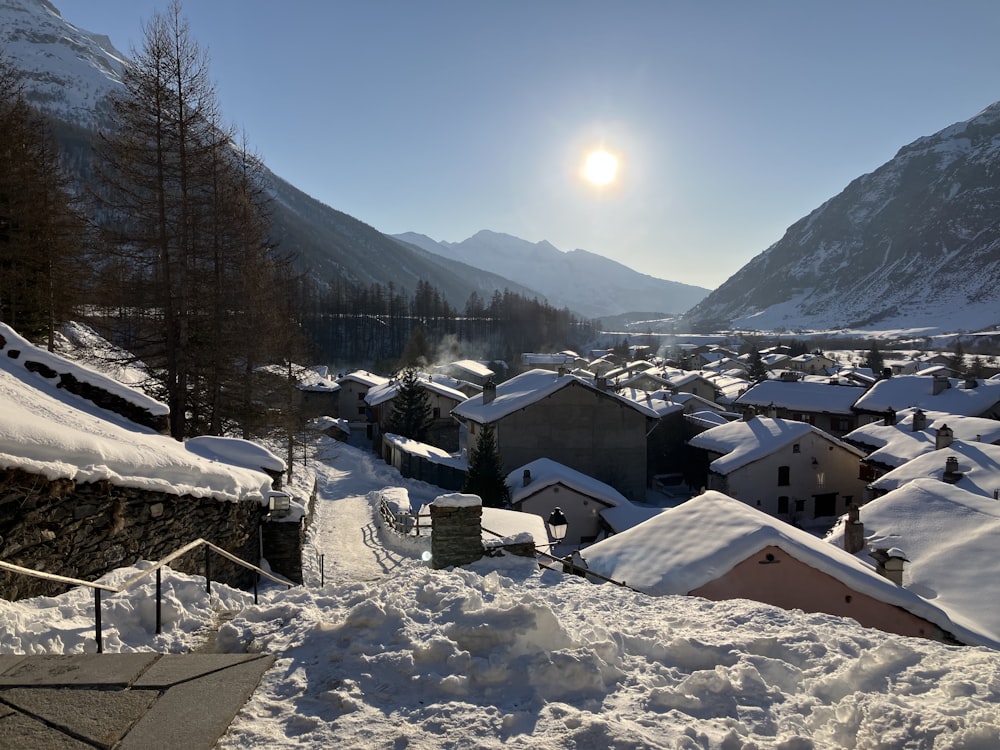 the sun is shining over a snowy village