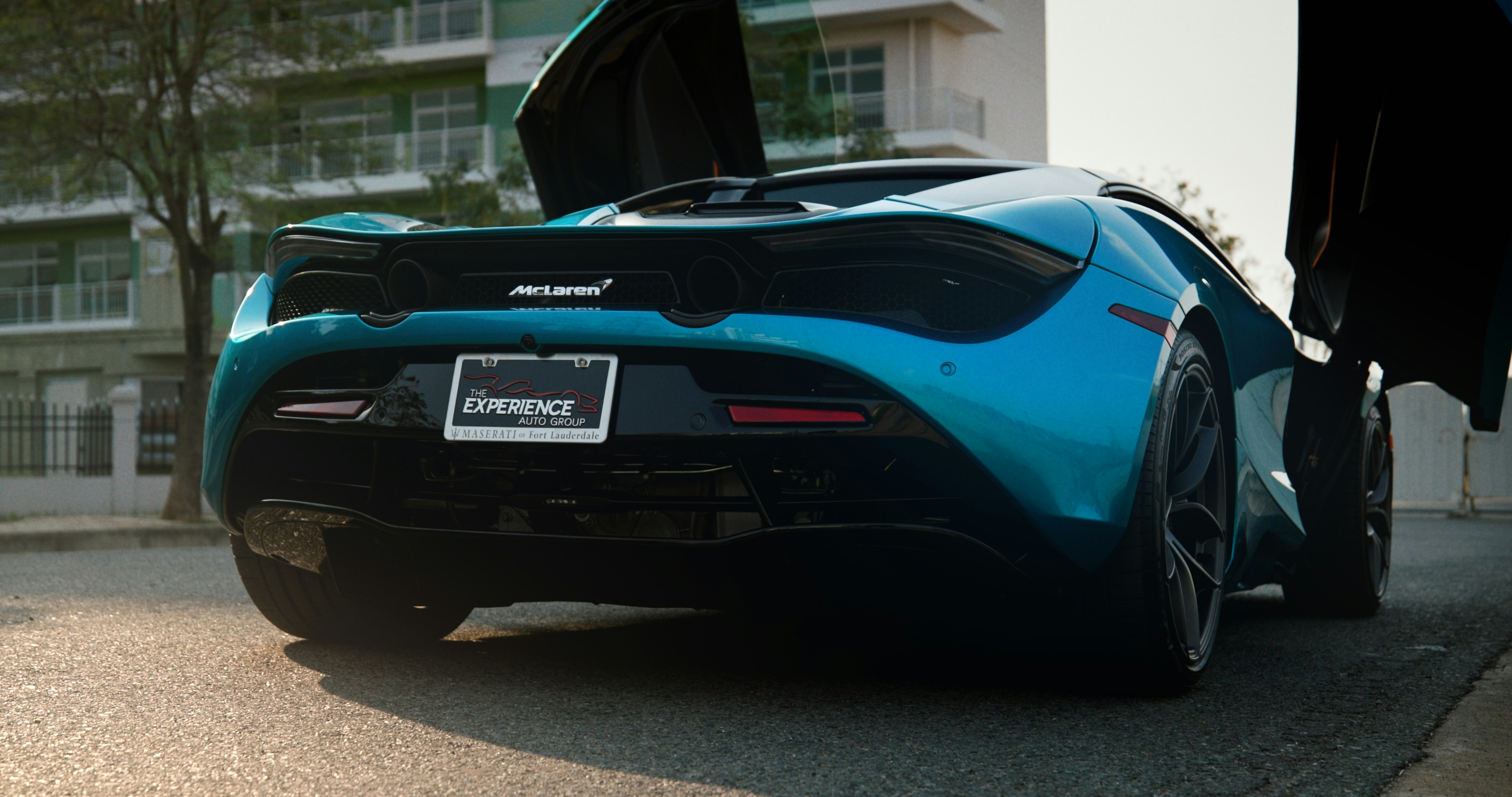 a blue sports car parked on the side of the road