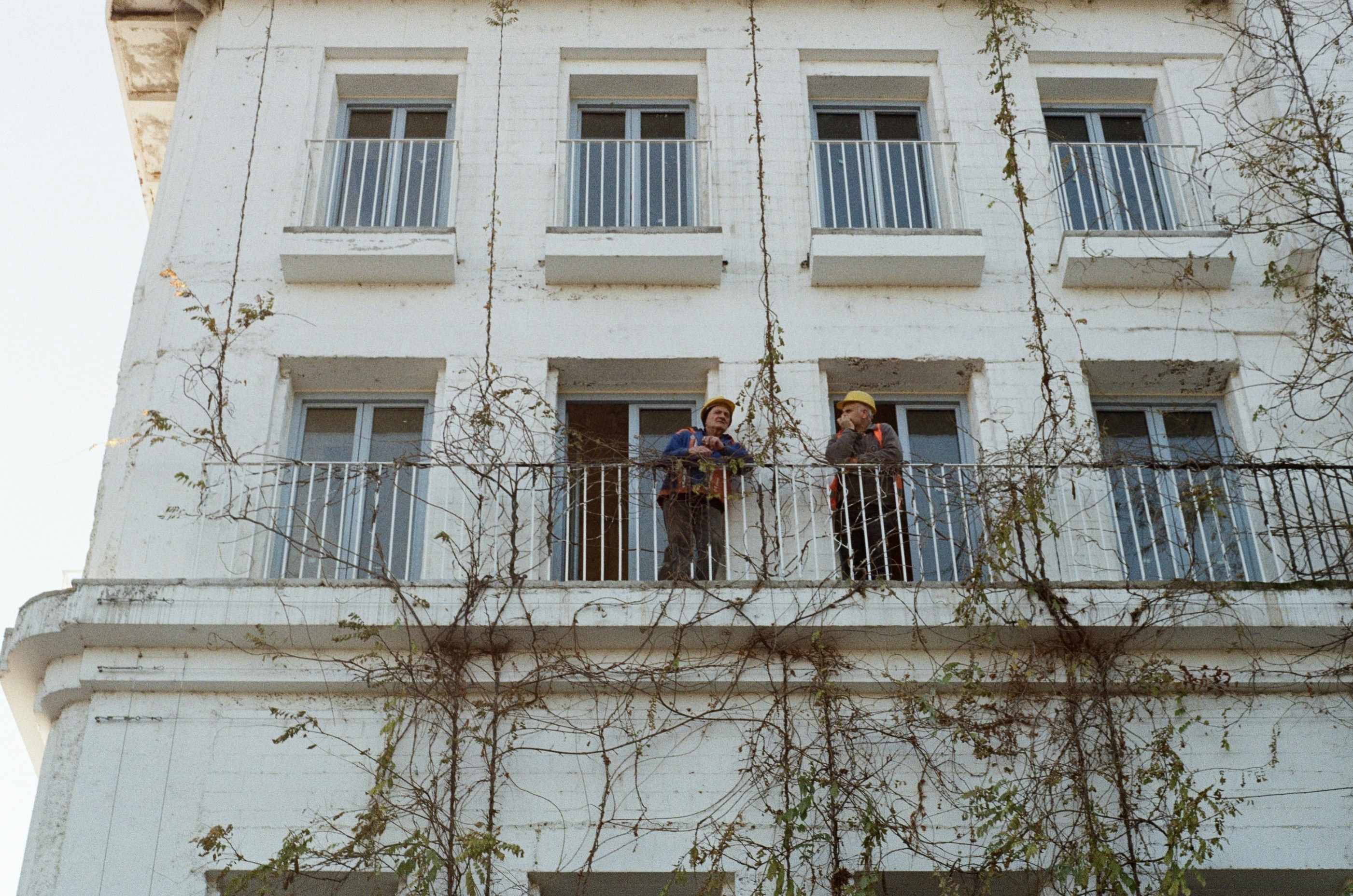 of two people happily touring a loft apartment with a leasing agent - lofts for rent near me