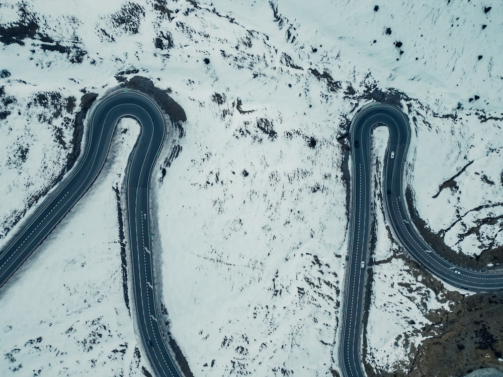 two winding roads in the middle of a snowy landscape