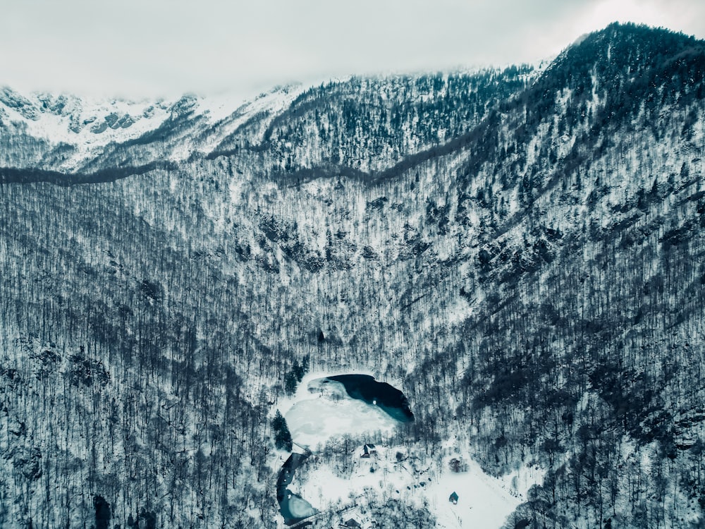 a snow covered mountain with a lake in the middle