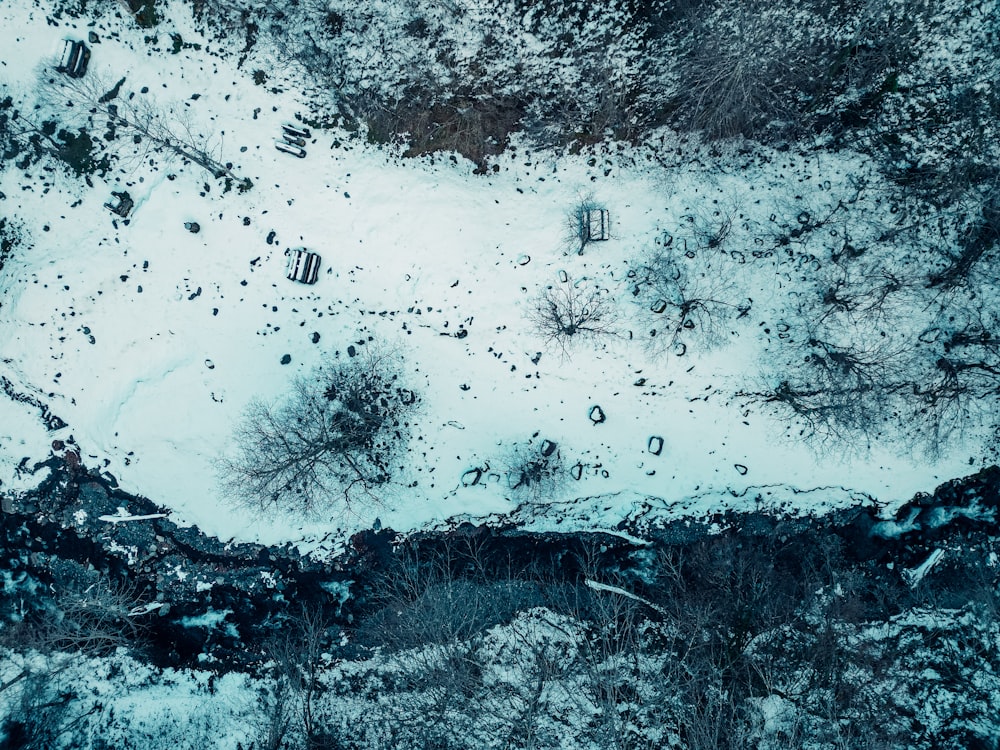 an aerial view of snow covered ground and trees