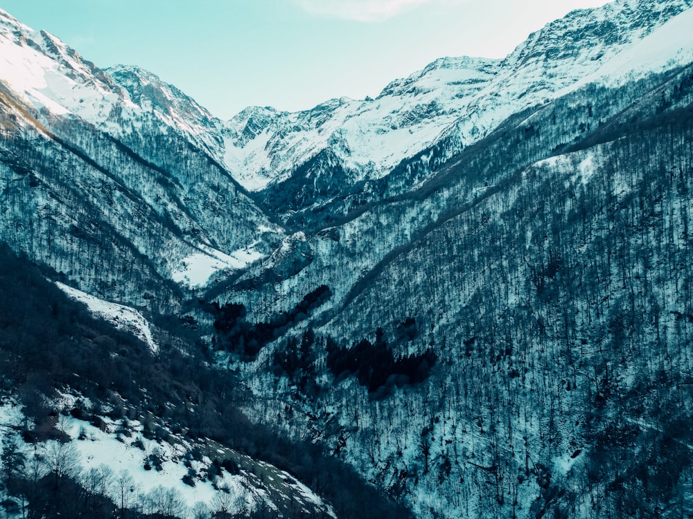 a view of a snowy mountain range in the mountains