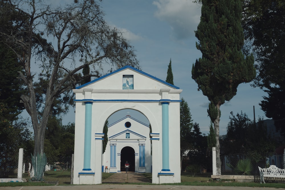 a white and blue church with a blue roof