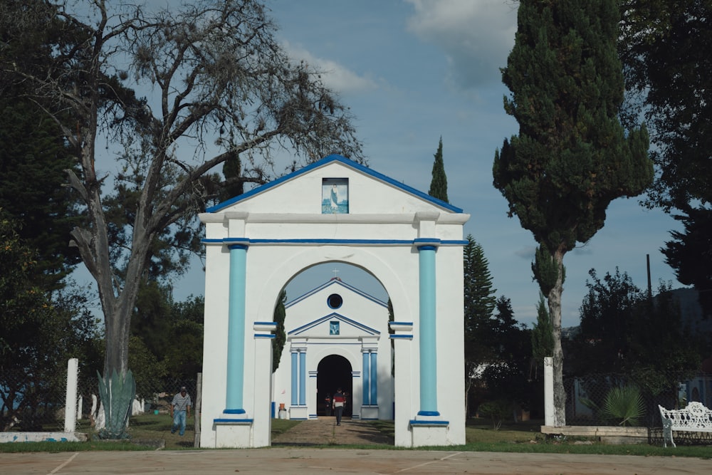 a white and blue church with a blue roof