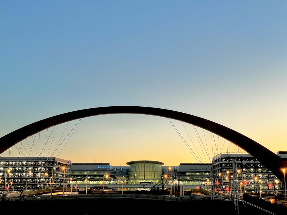 a large arch with a building in the background