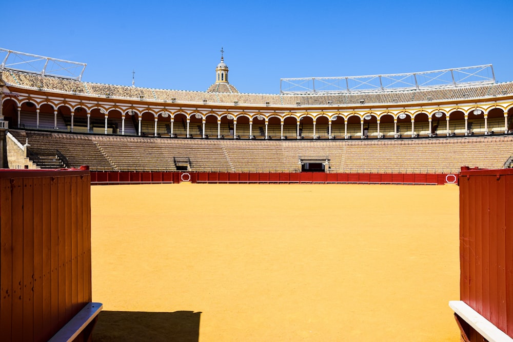 an empty stadium with a bench in the middle